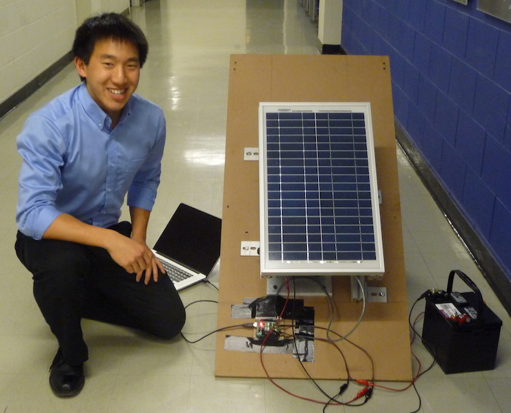 Photo of Joel and prototype of inclined rooftop solar tracker